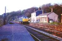 A Class 25 runs light engine towards Blackburn through the closed Wilpshire station on a fine spring evening in 1975. Although the platform on the left still exists that in front of the station building has now gone but the building itself survives as a home. When the line to Clitheroe reopened to passengers the new station, Ramsgreave and Wilpshire, was built some 400 yards south of here.<br><br>[Mark Bartlett /05/1975]