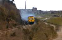 A class 101 Metro-Cammell 3 car DMU on a Dundee - Perth service in April 1979 is seen looking east from Riverside Drive as it approaches the site of Ninewells Jct. The junction which was on the Invergowrie side of the road bridge that takes Riverside Drive over the railway. With thanks to Bill Dryden for clarification of the location.<br><br>[John McIntyre /04/1979]