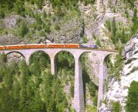 An eastbound <I>Glacier Express</I> for St. Moritz crosses the Landwasser Viaduct on the RhB network near Filisur in August 1998. The train is about to enter Landwasser Tunnel by the famous western portal where the viaduct meets a vertical cliff face.<br>
<br><br>[Fraser Cochrane /08/1998]