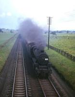 Black 5 no 45297 heads south with a train on the WCML near Plumpton on the approach to Penrith in the 1960s. [See image 34843]<br>
<br><br>[Robin Barbour Collection (Courtesy Bruce McCartney) //]