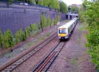 A down Clubman leaves High Wycombe station on the former four-track GC and GW joint section on 26 April 2014. That creeper on the cutting wall, which contains 1.2 million bricks - give or take a dozen - looks rather tenacious. [compare to image 49508]<br><br>[Ken Strachan 26/04/2014]