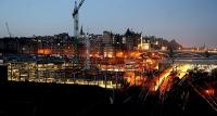 Early morning at Waverley in January 2006 with the lights of the new Edinburgh Council HQ construction site taking up most of the foreground of the picture.<br><br>[John Furnevel 03/01/2006]