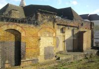 <h4><a href='/locations/S/Shoreditch_NL'>Shoreditch [NL]</a></h4><p><small><a href='/companies/N/North_London_Railway'>North London Railway</a></small></p><p>Remains of the North London Railway station at Shoreditch opened with the Broad Street branch on 1st November 1865 and closed after heavy war damage on 3rd October 1940, seen here from a passing London Overground train on 15th February 2014. This is all that is left at platform level of the station but up until closure of the Broad Street branch in 1986, the disused central island platform was still in position. That was swept away during the reconstruction of the line as part of the London Overground which opened in April 2010 with a new section of track linking it to the former LUL East London Line to enable trains to run through from north to south London. The new section includes a station at Shoreditch High Street, further south and which was preferred to rebuilding the original 1865 NLR station. (I travelled on the very first train south from Dalston Junction to New Cross back in 2010 and I still have fond memories of riding the line in the 1960s, 70s and 80s into and out of the moribund eyesore that the once great Broad Street station (now demolished) had sadly become.) 14/33</p><p>15/02/2014<br><small><a href='/contributors/David_Bosher'>David Bosher</a></small></p>