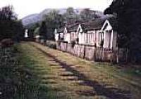 Looking west towards the former station by railway cottages at Aberfoyle. Impressions of sleepers remain on ground.<br><br>[Ewan Crawford //]
