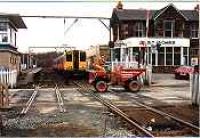 Looking north at Balloch Central across the level crossing. Class 314 in station.<br><br>[Ewan Crawford //]