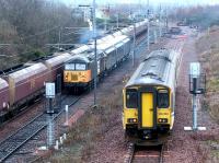 A busy scene at the north end of Millerhill yard on 10 December 2002. On the left a coal train is passing through behind a class 66, in the centre <I>Loadhaul</I> liveried 56118 is leaving for the north with a freight, while on the right 150250 is running into the turnback siding after recently terminating at Newcraighall on a service from Bathgate. The DMU will shortly form the next service to Dunblane.<br><br>[John Furnevel 10/12/2002]