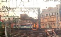 A Class 156 still in old ScotRail colours passes Bridge Street in the approach to Glasgow Central<br><br>[Graham Morgan 05/08/2006]