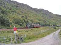 The Jacobite drops down to the crossing at Kinloid Farm between Arisaig and Morar.<br><br>[John Robin 22/08/2006]