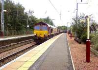 66099 passing through Johnstone Station with a loaded coal train heading for Longannet PS<br><br>[Graham Morgan 30/09/2006]