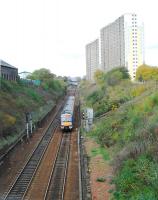 A service on the bidirectional track of the Cowlairs Incline which is overlooked by high flats.<br><br>[Ewan Crawford 04/11/2006]