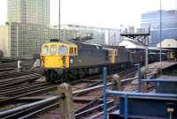 A pair of class 33s with a ballast train at Waterloo station in March 1976.<br><br>[John McIntyre 19/03/1976]