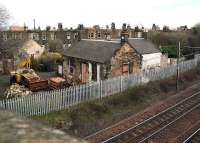 Remains of the old Joppa station, standing on the north side of the ECML, on 21 March 2007. The location is currently being used by a construction firm. The building centre left is the Portobello driving test centre. A signal box once stood on the platform below. View east from Brunstane Road bridge. [See image 35305]<br><br>[John Furnevel 21/03/2007]
