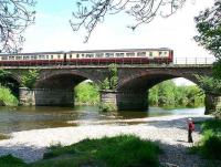A morning Glasgow Central - Carlisle service crosses the River Nith on 1 June 2007 as it begins to slow for the Dumfries stop.<br><br>[John Furnevel 01/06/2007]