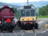 Class 107 DMU and a tanker in the yard at Boat Of Garten<br><br>[Graham Morgan 06/07/2007]