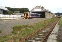 An afternoon train for Inverness waiting to leave Wick on 28 August 2007. The modern building on the far side of the station is the new police headquarters.<br><br>[John Furnevel 28/8/2007]