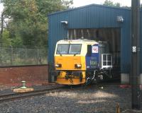DR 98958 stands at the entrance to the wheel lathe shed at Craigentinny on 28 September 2007, awaiting the next fall of leaves. Photographed from a passing train.<br><br>[John Furnevel 28/09/2007]