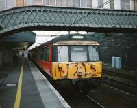 The 08.02 service to Garscadden formed by 303 023 stands at Carstairs in August 1997. <br><br>[David Panton 29/08/1997]