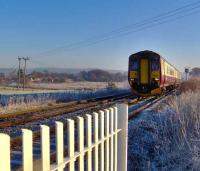 A Carlisle - Glasgow Central train heads for Dumfries along the G&SW route just west of Racks on a bright and frosty 17 December.  <br><br>[Brian Smith 17/12/2006]