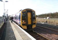 The 14.33 train to Edinburgh Waverley boards at Uphall on 15 February. Note the earth moving equipment at work on new access facilities on the the north side of the line in connection with the doubling of the route.   <br><br>[John Furnevel 15/02/2008]