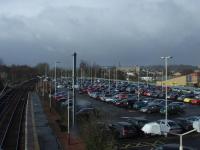 The car park at Johnstone station on 5th March. This is a typical weekday where there are too many cars and not enough spaces, as shown by the three cars parked next to the closest lamp post which have yellow stickers on them. This was the location of Johnstone shed and goods depot. <br><br>[Graham Morgan 05/03/2008]