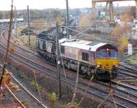 66142 comes off the Leith South branch at Portobello with a train of imported coal from Leith Docks to Cockenzie Power Station while in the background an unidentified 66 takes a train of empties down to the Docks for loading.<br><br>[Mark Poustie 25/11/2006]