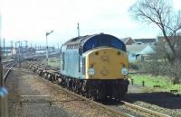 In its last month of working 40098 looks in fine fettle as it hauls container flats through Prestatyn. An opportune picture from a Crewe to Holyhead train that had stopped in the station. Withdrawn in April 1981 the loco was cut up at Swindon two years later. <br><br>[Mark Bartlett 15/03/1981]