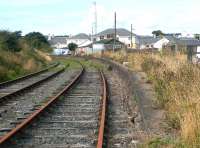 The abandoned Stranraer Town station in August 2003 looking west towards Portpatrick. The boarded up station building still stands in the background. Stranraer Town closed to passengers in March 1966.<br><br>[John Furnevel 17/08/2003]