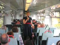 Ishbel McFarlane entertaining passengers on one of the First ScotRail Edinburgh - Glasgow via Shotts services as part of The Arches 'On the Verge' festival. <br><br>[First ScotRail 24/06/2010]