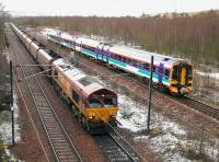 Scene at the north end of Millerhill yard on 22 March 2005. A train of coal empties is heading for Niddrie West Junction and the 'sub' after a signal check. The cause of the delay, a recently arrived Bathgate - Newcraighall DMU, has just run into the turnback siding. The 4-car train will form the next service to Dunblane.<br><br>[John Furnevel 22/03/2005]