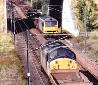 North end of Millerhill in September 1997, with 37108 on a departing PW train about to pass 60058 with the returning Lackenby steel flats.<br><br>[John Furnevel 16/09/1997]