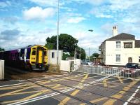 158759 hurries eastwards through Hospital Crossing on a Blackpool to York service. The crossing is next to a busy road junction and is not automatic but controlled and monitored from Bamber Bridge signal box. It is a cramped location for photographers though.  <br><br>[Mark Bartlett 16/08/2008]
