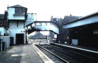 The unique signal box and footbridge arrangement at Broughty Ferry. Photographed in August 1985 looking over the level crossing towards Aberdeen.<br><br>[David Panton 22/08/1985]