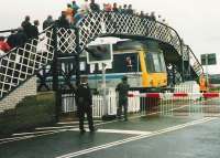 <I>NO, NO!!! ...A SEVEN IRON, A SEVEN IRON....!!!</I> The driver of a <i>Golfers Special</i> DMU is temporarily distracted prior to leaving the platform at Carnoustie for the siding during <I>The Open Golf Championship</I> on 17 July 1999. <br><br>[David Panton 17/07/1999]