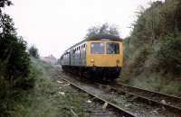A DMU railtour carefully picks its way along the branch to Norwich Victoria coal depot late on a Saturday afternoon in October 1980. The passengers had previously been treated to a run up to Great Ryburgh and back via Dereham. Originally a passenger terminus, Norwich Victoria station closed in 1916, but the branch lingered on for goods, and latterly coal, until 1986. Predictably perhaps, the site of the coal depot now lies under a Sainsburys supermarket.<br><br>[Mark Dufton 11/10/1980]