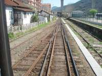 <I>Modelling challenge?</I>The Douro Valley main line is mixed gauge from the junction at Corgo to the large station at Regua, where the tracks fan out into separate yards and bays on either side of the line. This view of the complicated pointwork is from the window in the rear corridor connection of a Pocinho to Porto train approaching Regua.<br><br>[Mark Bartlett 20/03/2008]