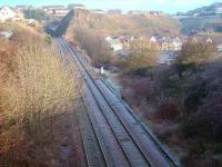 View north towards Kinghorn tunnel with part of the trackbed of the short, steeply-graded, Pettycur Harbour branch visible on the right. Opened in 1849, the line was subsequently cut back to serve a bottle factory, located where the modern housing now stands. The branch closed completely in the 1960s and the old factory was eventually demolished in 1984.<br>
<br><br>[David Panton 01/12/2008]