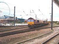 An infrastructure train heads south into York behind EWS 66238, viewed from the Scarborough platform. The National Railway Museum, and the Yorkshire Wheel in the museum grounds, can be seen behind the train. <br><br>[Mark Bartlett 11/10/2008]