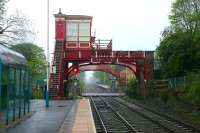 View east along the staggered platforms at Wylam, on the Newcastle & Carlisle line, looking over Station Road level crossing on a Sunday morning in May 2006. There has been a station here since March 1835. Wylam is claimed by many to be <I>...'the oldest railway station in the world, with original buildings, still in constant use'</I>.  <br><br>[John Furnevel 07/05/2006]