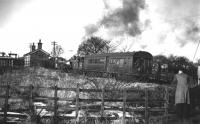 There is still some snow on the ground as 50731 pulls its autocoach into Woolfold station on its way from Bury Bolton Street to Holcombe Brook, the scene captured by Cam Camwell and his pals in February of 1952. This picture, looking towards Tottington and Holcombe Brook, shows the buffers of the elevated sidings in the goods yard behind the station building, all now swept away. <br><br>[W A Camwell Collection (Courtesy Mark Bartlett) 03/02/1952]
