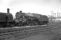 Of the 842 Stanier Black 5s built, only five carried a name during their normal operational service. One of these, no 45157 <I>The Glasgow Highlander</I>, stands at Stirling South shed c. 1958.<br>
<br><br>[K A Gray //1958]