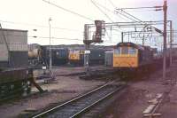 08788, now the Inverness shunter, is glimpsed here in 1979 stabled at Bescot Depot alongside 56045, later in service as Fastline's 56301 and now preserved. Class 25, Bo-Bo Type 2, 25300 rumbles through with a freight on the line behind the station platform having arrived from the north. This loco was less fortunate, being withdrawn from Crewe in 1985 and cut up at Doncaster the following year. <br><br>[Mark Bartlett 18/04/1979]