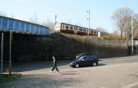 A westbound train, having crossed Duke Street, heads for Glasgow city centre on 2 April 2009. What is now <I>The Forge</I> shopping centre stands beyond the twin bridges on the other side of the embankment.<br><br>[John Furnevel 02/04/2009]