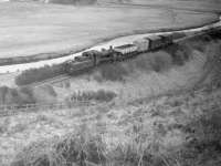 Tweedmouth shed's Standard class 2 2-6-0 no 78012 seen here between Kirknewton and Mindrum on the Wooler line with the <I>Tuesdays and Thursdays only</I> branch freight on 10 February 1964, six weeks before final closure.<br><br>[Robin Barbour Collection (Courtesy Bruce McCartney) 10/02/1964]