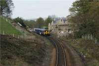 A Clitheroe to Manchester Victoria service operated by Northern Rail using 156497 passes the former station at Turton on 18 April 2009.<br><br>[John McIntyre 18/04/2009]