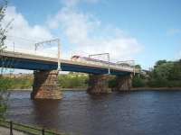 Carlisle Bridge, Lancaster, carrying the West Coast Main Line over the River Lune and seen here at High Tide from St. Georges Quay on the south side. The bridge was substantially rebuilt in the 1960s and a footbridge added to the east side as seen here. The southbound Pendolino is slowing for the Lancaster stop. The old Morecambe to Lancaster Green Ayre line passed under an arch of this bridge on the far bank.  <br><br>[Mark Bartlett 07/05/2009]