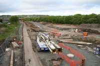 Looking North toward Bathgate town centre on 23 May 2009. A temporary road is under construction which crosses the bed of the <i>Bathgate and Coatbridge Railway</i> at the site of <i>Polkemmet Junction</i> to allow the replacement of the Whitburn Road overbridge in Bathgate. The solum of the railway is to the left of the image, while the treeline to the right marks the course of the <i>Wilsontown, Morningside and Coltness Railway</i><br><br>[James Young 23/05/2009]