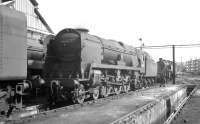 Bulleid <I>West Country</I> Pacific no 34005 <I>Barnstaple</I> in the yard at Nine Elms c 1965. The locomotive was withdrawn by BR in March of 1967, a few months prior to the final closure of the shed itself. The former 15 road shed with its large yard and adjoining goods depot is now the site of London's wholesale fruit and vegetable market. <br>
<br><br>[K A Gray //1965]