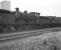 A line of <I>stored</I> locomotives, including 64466 and 69012, stand in the sidings at Thornton Junction MPD in the 1960s, with one of the towers enclosing the headgear of Rothes Colliery in the background.<br><br>[K A Gray //]