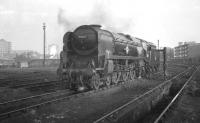Rebuilt <I>Merchant Navy</I> Pacific no 35017 <I>Belgian Marine</I> takes on water at Nine Elms shed in the mid 1960s.<br><br>[K A Gray //1965]