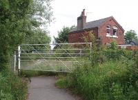 Originally a full vehicle crossing, but for many years restricted to pedestrians only, this is New Road on the mothballed Fleetwood Branch just south of Thornton-Cleveleys station. New Road is shown in Quails Track Diagrams as <I>Tarn Gate</I>. The crossing keeper's cottage is in private ownership and at the time of this photograph was <I>For Sale</I>. <br><br>[Mark Bartlett 10/06/2009]